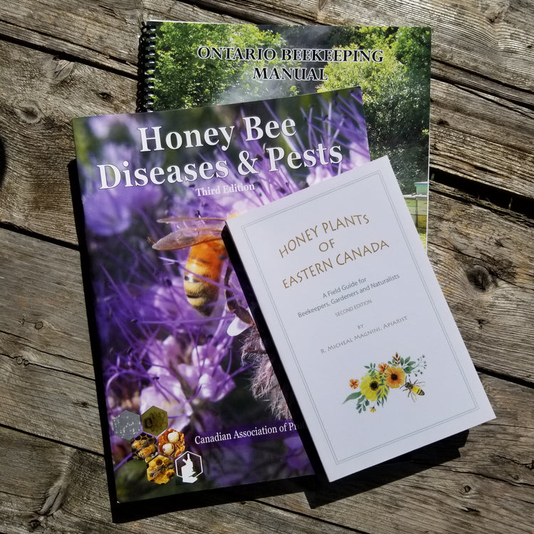 honey bee books in a stack