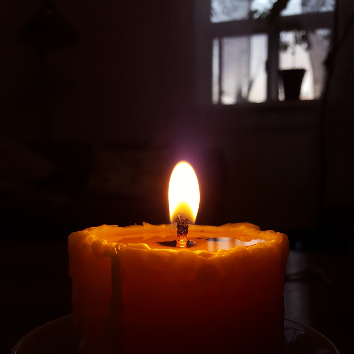 glowing beeswax pillar candle