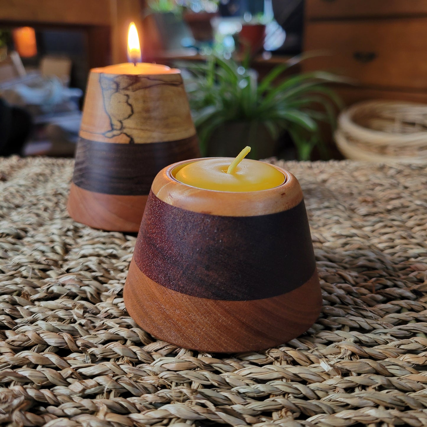 Wooden candle holder with a candle on a woven surface
