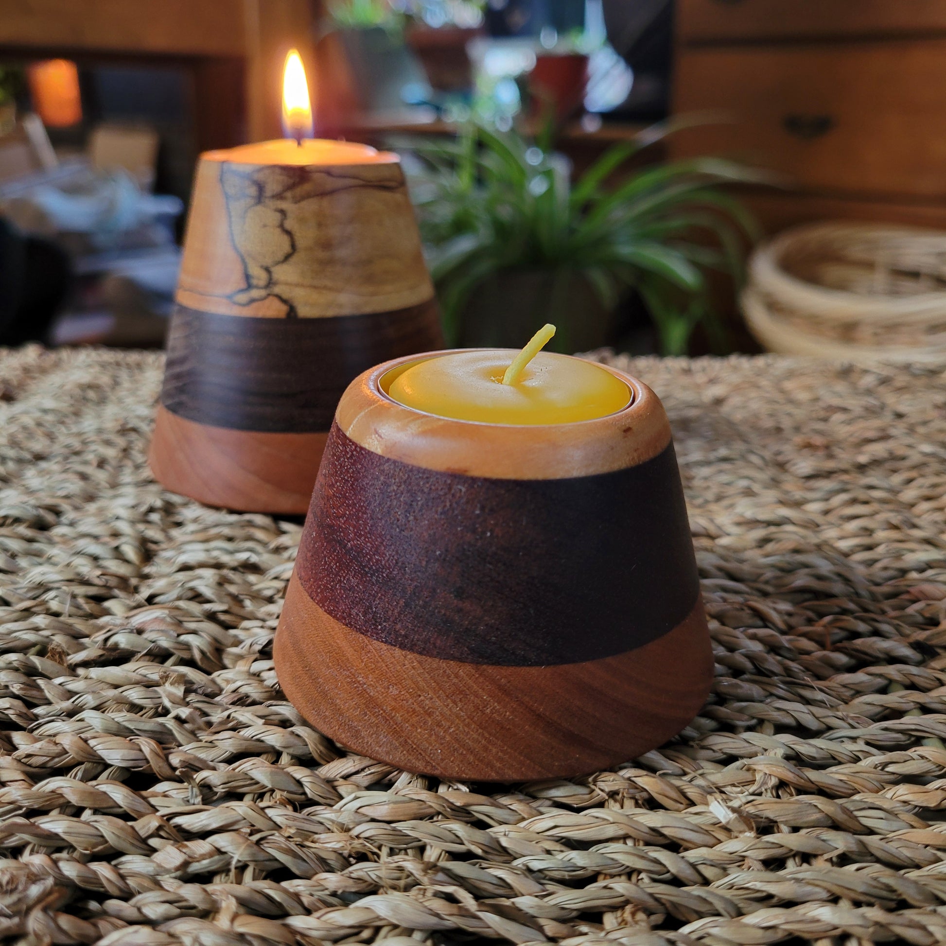 Wooden candle holder with a candle on a woven surface