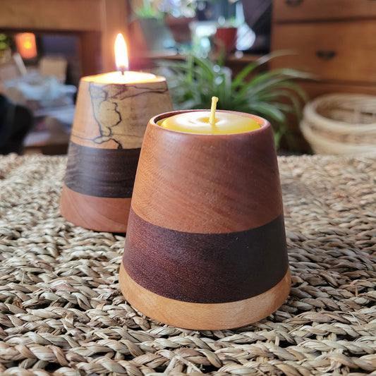 Wooden candle holder with a candle on a textured surface