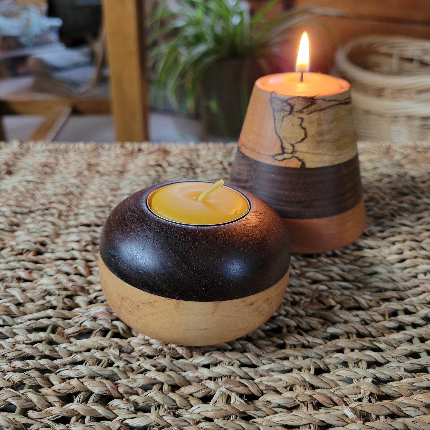 wooden tealight holder sits on a wicker table