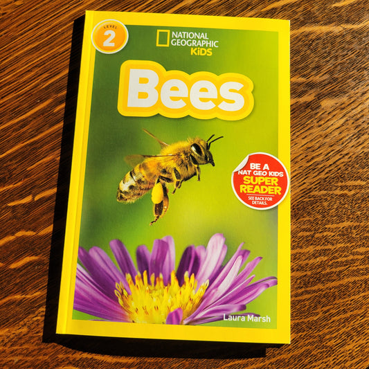 Book titled 'Bees' by National Geographic Kids on a wooden surface