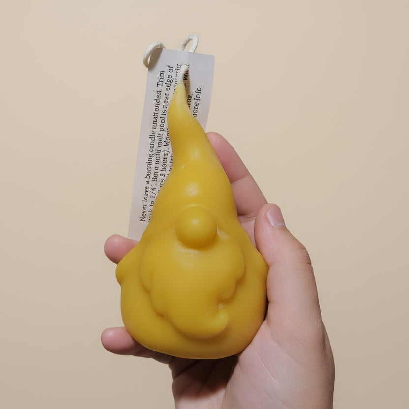 Grimble Grumble beeswax gnome candle held by a hand