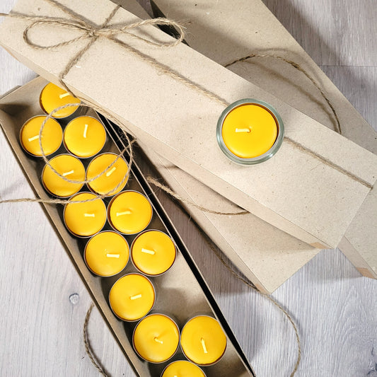 one box of tealights opened with a tealight sitting on top of additional boxes besided the opened one