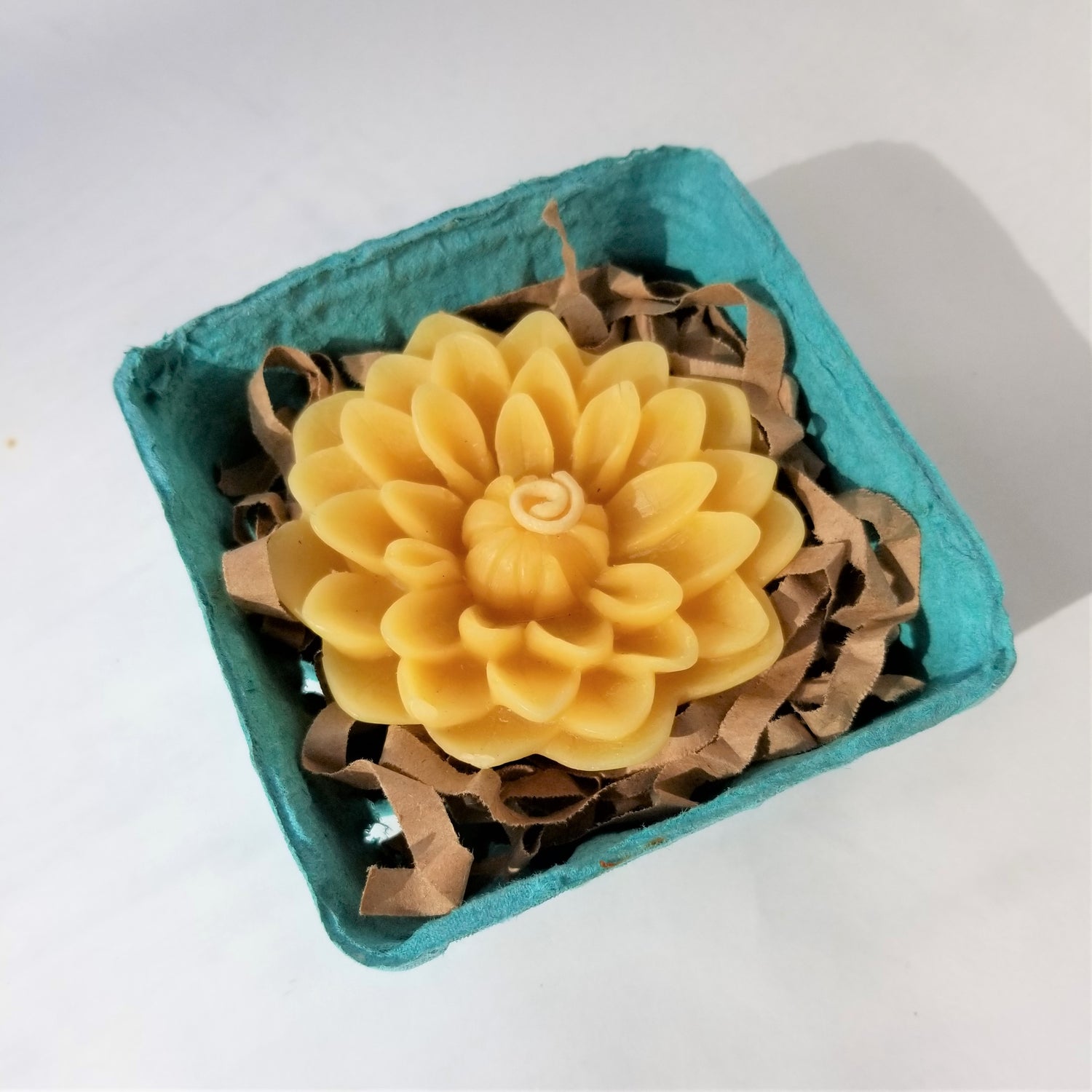 Yellow beeswax dahlia candle packaged in berry box