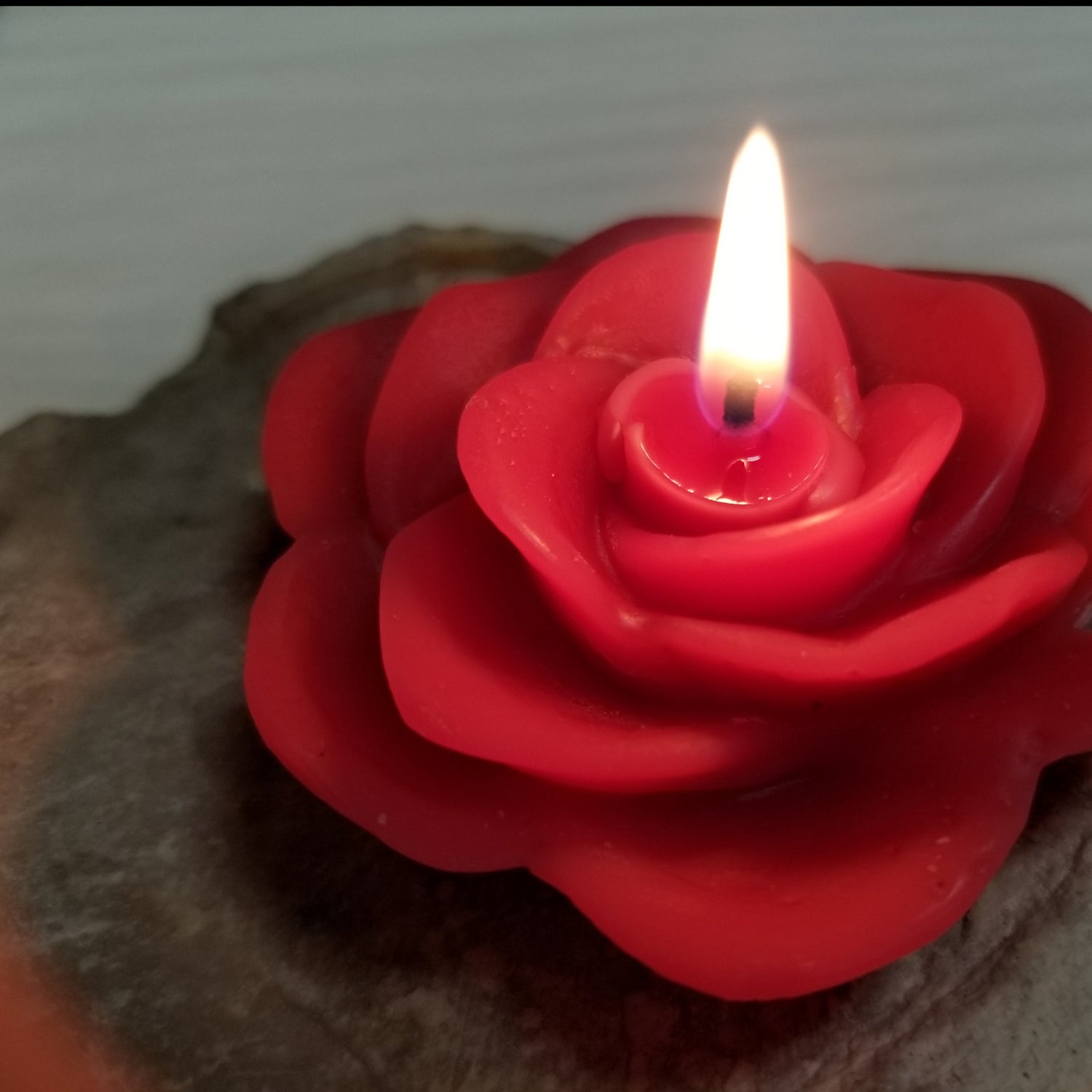 red rose candle burning