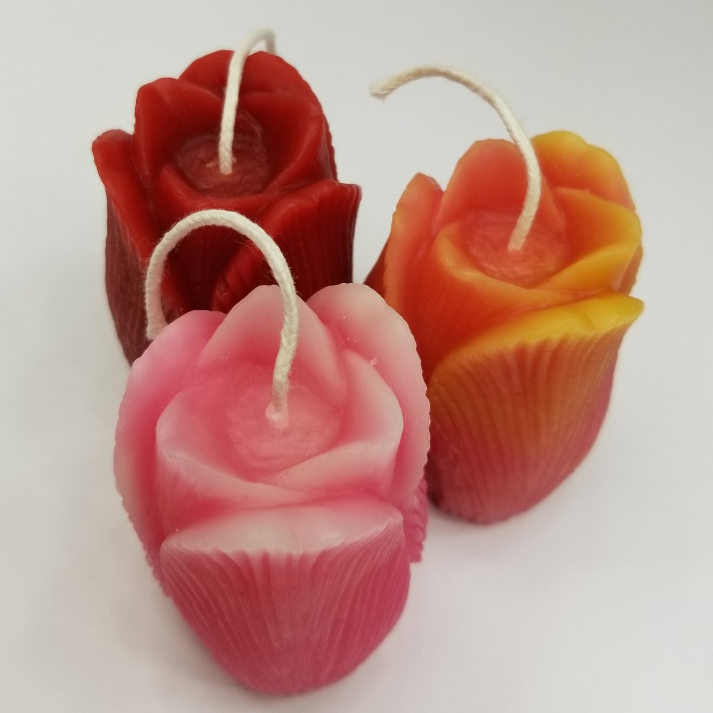 three tulip candles; one red, one pink & yellow, one pink and white