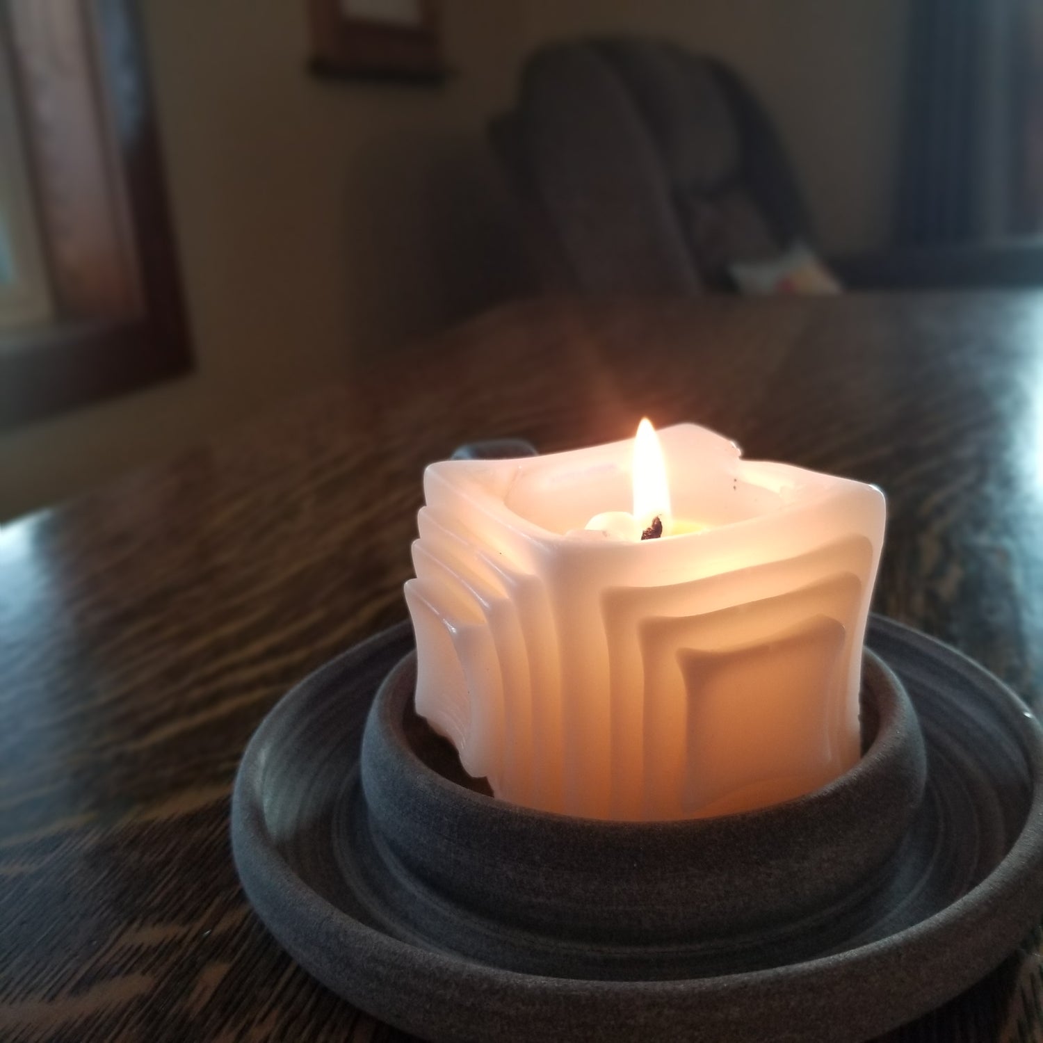 Pure beeswax white squares on squares pillar candle lit/burning; home decor,  geometric, modern decor