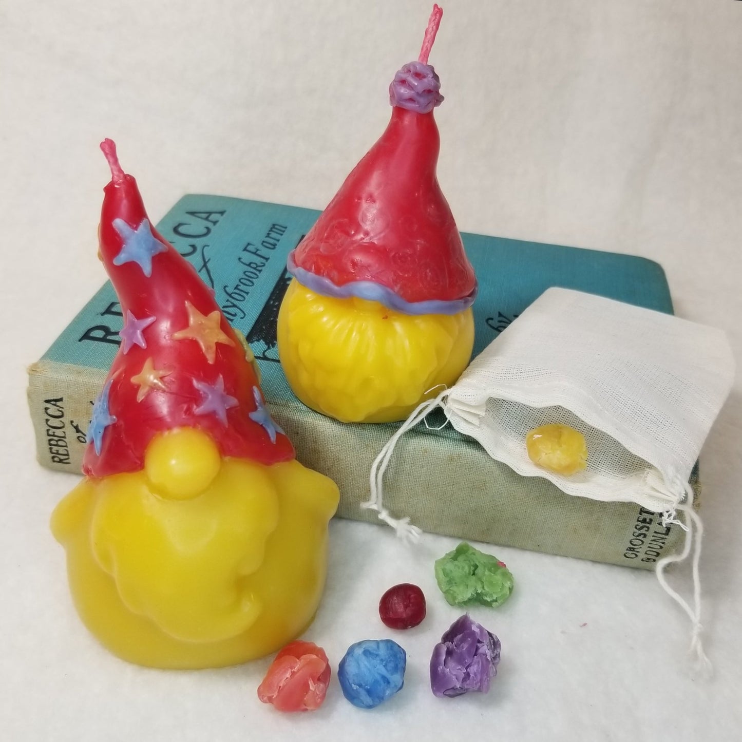 DIY gnome decorating kit - image shows decorated gnome candles and bag of wax that comes in the DIY kit