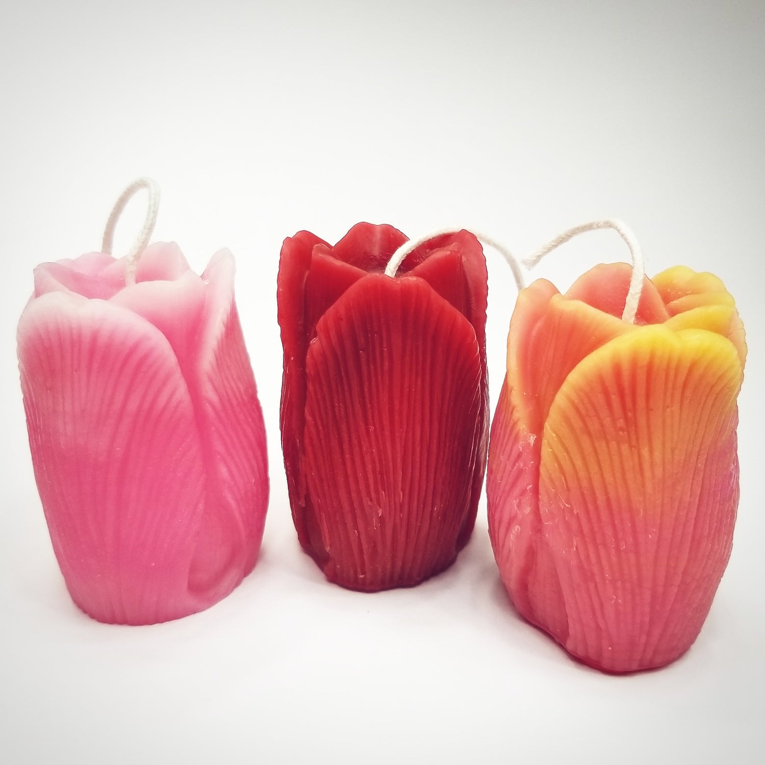 three tulip candles; one red, one pink & yellow, one pink and white